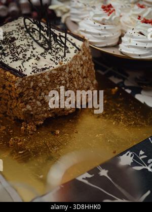 Rectangular Anthill Cake on Gold Cake Board and Beze (Meringue) Desserts Stock Photo
