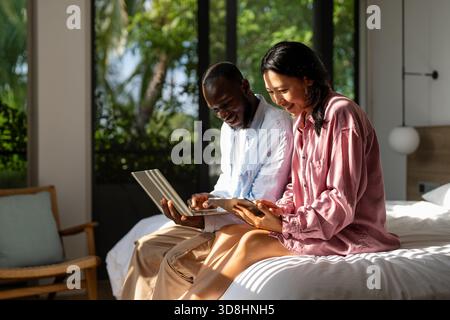Couple of freelance IT specialists using digital technology devices while working remotely from home Stock Photo