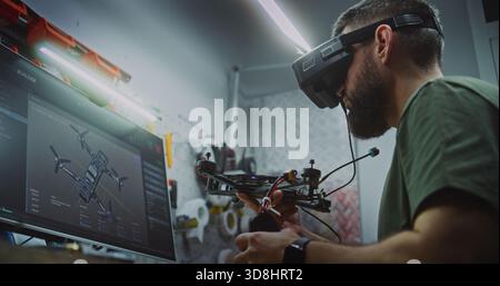 Bearded Man in Tactical Gear Deeply Focused, Using Computer Display and FPV Gear While Working on Drone Electronics. Engineer Utilizing Digital and Physical Tools. Dedication to Military Grade Tech. Stock Photo