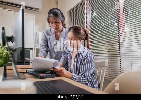 Young women business team work at home office, collaborating on project, discussing important Stock Photo