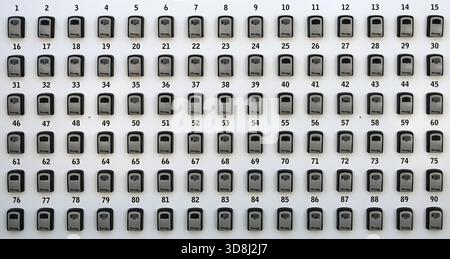 Lines or Rows of Numbered Key Boxes, Lock Boxes or Security Boxes. Ninety Key Boxes Stock Photo