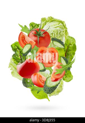 Fresh vegetables background. Summer salad ingredients - tomatoes, cucumbers, leafy greens, chinese cabbage flying as swirl, isolated. Perfect for orga Stock Photo