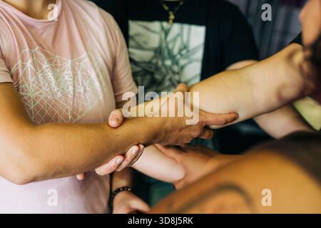 Group of people joining hands showing teamwork and unity Stock Photo