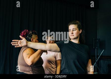 Women rehearsing movement in a dance studio Stock Photo