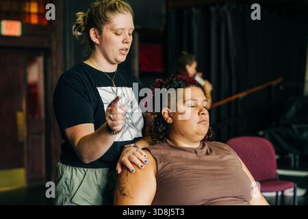 Coach instructing woman during a focused workshop Stock Photo