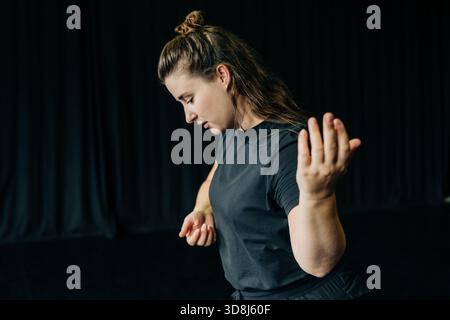 Woman practicing contemporary dance during rehearsal Stock Photo