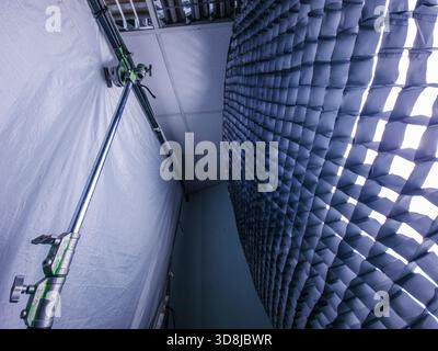 Interior view of modern photography studio setup featuring a large softbox with a grid attached to light stand and white backdrop for creative product Stock Photo