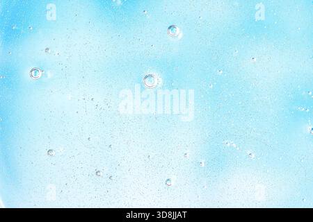 Textured pale blue and white background with numerous small air bubbles and subtle grain, creating a fresh effervescent abstract surface. Stock Photo