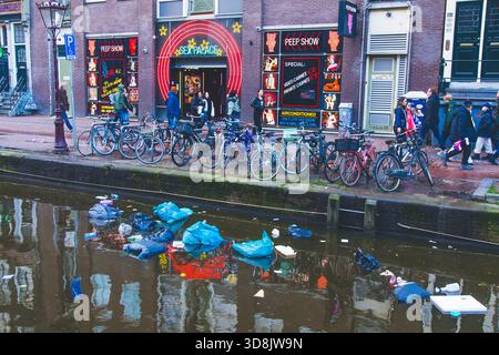 Europe, Netherlands, Amsterdam. Rubbish floats on the canal in the city centre Stock Photo