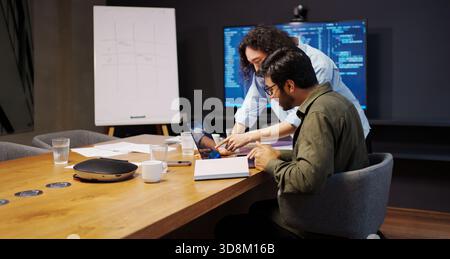 design review session, collaborative team deeply analyzing user interface designs and solutions Stock Photo
