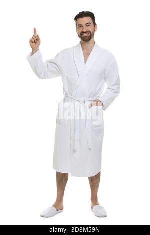 Man in bathrobe pointing at something on white background Stock Photo