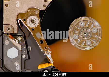 A detailed view of the internal components of a hard drive, showcasing mechanical parts, platters, spindle motor hub and circuitry. Stock Photo