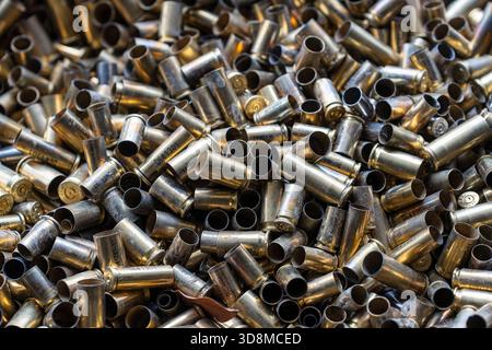 Pile of used pistol cartridges, close up. Bunch of empty pistol shells as a background Stock Photo