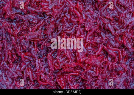 Background and texture of raw fresh juicy grated red beetroot vegetable, close up, top view Stock Photo