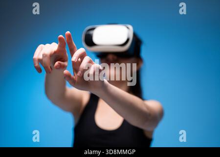 VR designer using hand gestures to manipulate virtual interface while crafting digital creative concepts Stock Photo