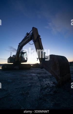 A digger stands idle on a cold December evening in Kilcreggan, Helensburgh, Scotland. Stock Photo
