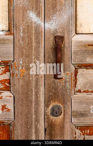 close-up of an old door, with rusty door handle and lock, graphic abstract Stock Photo