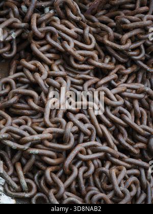 Rusted, intertwined chains symbolizing the burden and complexity of mental health struggles, resilience, and interconnected challenges, Brixham, Devon Stock Photo