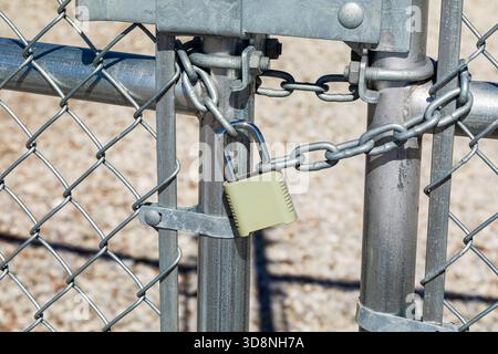 Chain and padlock on gate. Property security, crime prevention and lock maintenance concept. Stock Photo