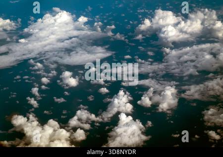 Aerial view of fluffy white clouds over a deep blue ocean. Stock Photo