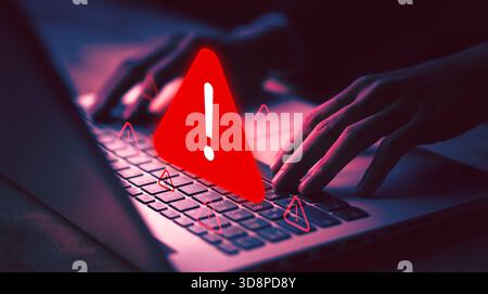 Cybersecurity warning with red alert sign on laptop, symbolizing online threat, hacking danger, virus alert, cyber attack, data protection, and digita Stock Photo