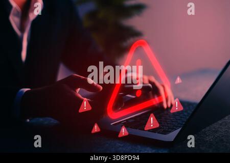 Cybersecurity alert with warning icon displayed on screen, representing digital threat, hacking risk, malware, phishing, and internet data breach in a Stock Photo