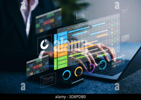 Project management dashboard. Businessman using digital laptop with timeline, charts, and task tracking for productivity, planning, and data analysis Stock Photo