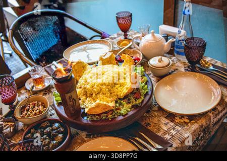 Azerbaijan, Baku. Shah pilaf. Khan pilaf in a pita. Traditional oriental dish on tableware. Shah Pilaf with fire on a table in restaurant. Stock Photo