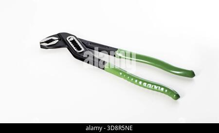 A pair of pliers with green grips lies on a clean white background. The tool features a metal jaw designed for gripping and twisting various materials Stock Photo