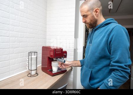 Man preparing coffee in his home kitchen Stock Photo