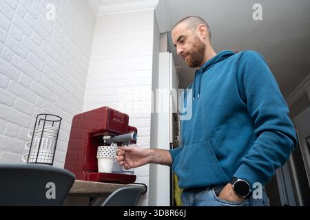 Man preparing coffee in his home kitchen Stock Photo