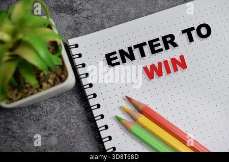 Concept of enter to win write on book isolated on Wooden Table. Stock Photo
