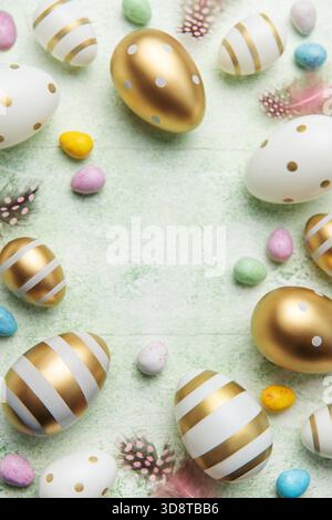 Decorative colored Easter eggs on a green wooden background. Festive background with place for text. The concept of Easter holidays. Stock Photo