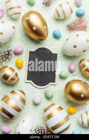 Decorative colored Easter eggs on a green wooden background. Festive background with place for text. The concept of Easter holidays. Stock Photo