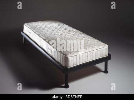 Still life of a single mattress, on a neutral background Stock Photo