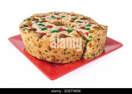 A homemade traditional light fruitcake on a white background. Stock Photo