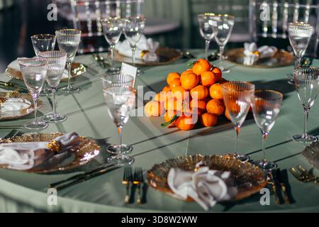 Centerpiece of stacked tangerines on a luxury banquet table Stock Photo