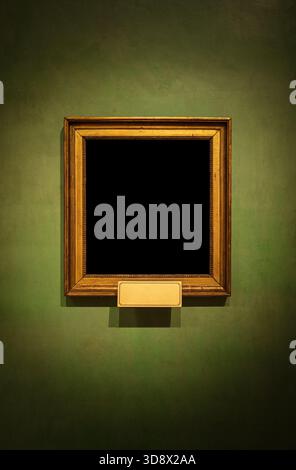 Ornate golden frame on a green wall. Vintage luxury style mockup with black copy space for portraits or art. Stock Photo