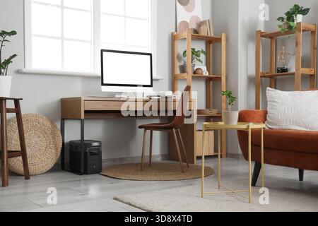 Programmer's workplace with computer and devices in living room Stock Photo