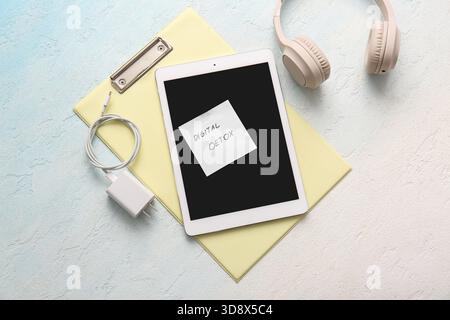 Sticky note with text DIGITAL DETOX, modern gadgets and clipboard on light background Stock Photo