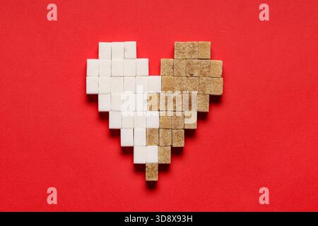 Heart made of sugar cubes on red background Stock Photo