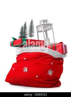 Santa Claus bag with gifts, lantern and mini Christmas trees isolated on white background Stock Photo