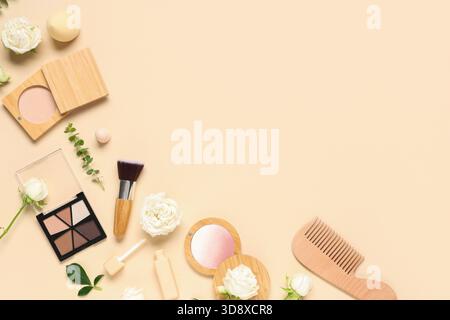 Frame made of white rose flowers and makeup products on beige background Stock Photo