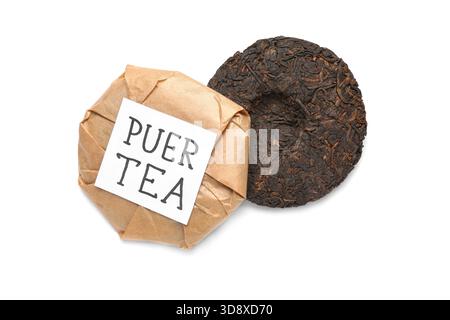 Dry pressed puer tea and sticky note on white background Stock Photo
