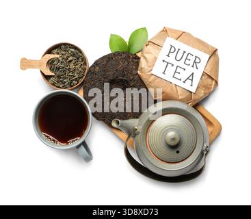 Dry pressed puer leaves with teapot, cup of tea and sticky note on white background Stock Photo