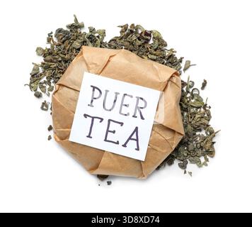 Dry pressed puer tea wrapped in paper and sticky note on white background Stock Photo
