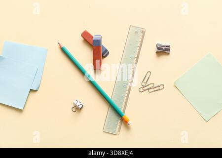 Erasers with stationery on light yellow background Stock Photo