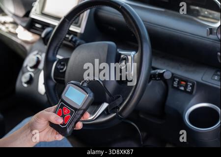 Woman using OBD2 diagnostic scanner.  Stock Photo