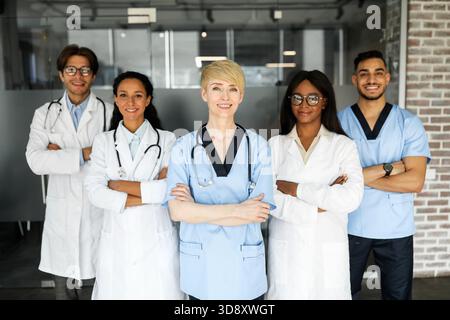 Friendly multiracial doctors team posing at hospital Stock Photo