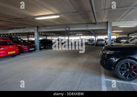 Interior of a multi-story car park in Cambridge, UK, with parked cars and concrete structure Stock Photo